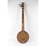 A carved wooden sitar, length 112cm.