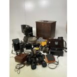 A quantity of cameras, a Kodak film projector, films and spools, binoculars and accessories.