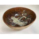 A studio pottery bowl with brown glaze interior. Condition Report: there appears to be no chips,