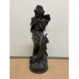 AFTER ALBERT-ERNEST CARRIER-BELLEUSE; a modern bronzed resin figure of a woman clutching a pair of