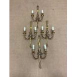 Four gilt brass wall sconces in the form of decorative swags, height 59cm.