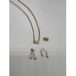 A small group of 9ct gold jewellery comprising two fine link chains supporting pendants, two pairs