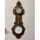 A circa 1900 carved oak barometer with rope and anchor decorated case, set with timepiece