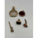 Three 19th century 9ct yellow gold mounted fobs, two set with polished bloodstone, a larger yellow