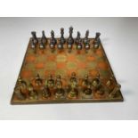 A contemporary weighted mixed metal chess set, with board, height of king 10cm.