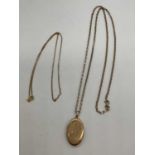 A 9ct yellow gold oval hinged locket with part engraved detail suspended on a 9ct gold chain,