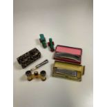 A small group of collectors' items including a pair of opera glasses, two harmonicas and two Dinky