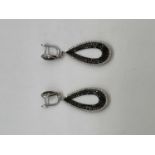 A pair of 18ct white gold black and white diamond set pierced drop earrings combined set with two