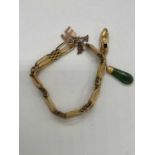 A 9ct yellow gold gate link bracelet suspending a nephrite jade and slipper pendant, length