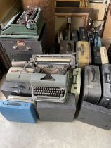 A large quantity of vintage typewriters.