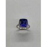 A platinum tanzanite and diamond ring, the translucent royal blue tanzanite weighing 9.32cts