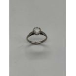 An early 20th century platinum diamond solitaire ring, the raised round brilliant cut diamond