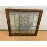 A leaded glass window decorated with a galleon at full sail, height 80cm, width 86cm.