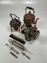 A Calcia King bike lamp, various veterinarian chrome syringes and assorted brass items. (8)