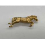 A 9ct yellow gold brooch modelled as a leaping horse, 53mm, approx 14.6g.