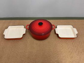 LE CREUSET; a cast iron large casserole and two roasting dishes.
