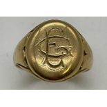 An 18ct yellow gold signet ring engraved with initials to the oval platform, size T, approx. 10.1g.