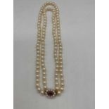 A hand tied double strand of pearls with 9ct yellow gold amethyst and pearl clasp, length 40cm,