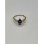 A 10ct yellow gold tanzanite and diamond ring, the boat shaped six claw set tanzanite flanked by
