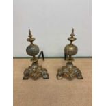 A pair of 18th/19th century brass andirons with globular fret detailed spheres beneath turned