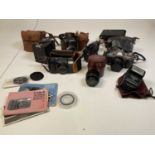 A group of cameras and lenses including a Carl Zeiss Jena F=28mm 1:2.8 cased lens.