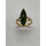 An 18ct yellow gold jade boat shaped ring, size N, approx. 5.9g.