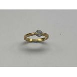 An 18ct yellow gold and diamond solitaire ring, the round brilliant cut collet set stone weighing