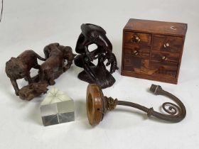 Two wooden carvings of mammals and birds, specimen wooden drawers, brass wall lamp and glass block.