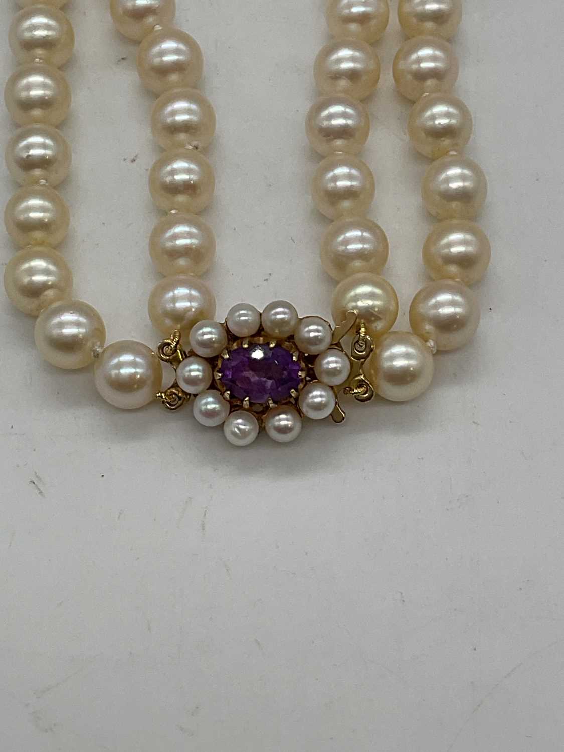 A hand tied double strand of pearls with 9ct yellow gold amethyst and pearl clasp, length 40cm, - Image 2 of 4