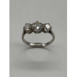 A platinum and diamond three stone ring, the central stone approx. 1ct, flanked by twin diamonds