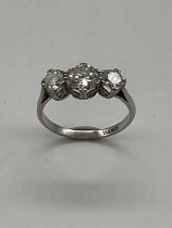 A platinum and diamond three stone ring, the central stone approx. 1ct, flanked by twin diamonds