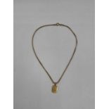 A 9ct yellow gold box link chain supporting a yellow metal engraved pendant, length of chain 40cm,