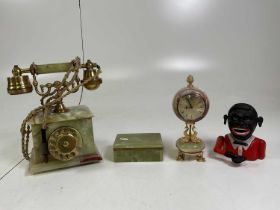 An onyx clock, together with a onyx telephone, an onyx box, and a reproduction money box