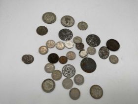A small group of coins, including sixpences, shilling, etc.