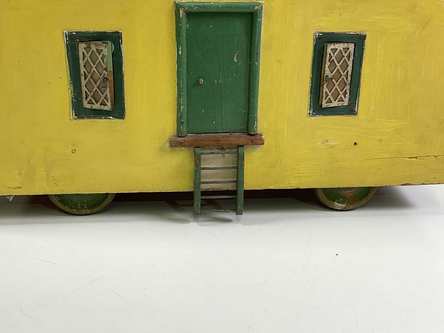 ATTRIBUTED TO TRI-ANG; a cream and green 1950's caravan with two small opening windows on one side - Image 5 of 6