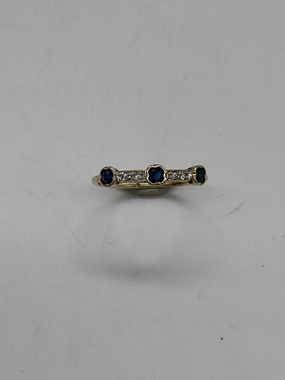 A yellow metal sapphire and diamond dress ring of Art Deco design, size K, approx. 1g.