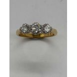 An 18ct yellow gold three stone graduated diamond ring, the centre stone approx. 0.40cts, size J 1/