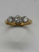 An 18ct yellow gold three stone graduated diamond ring, the centre stone approx. 0.40cts, size J 1/
