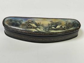 A Russian lacquered box featuring a traditional scene, width 19.5cm