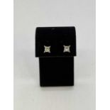 A pair of 18ct white gold diamond earstuds, the princess cut stones weighing 0.48and 0.50cts, graded
