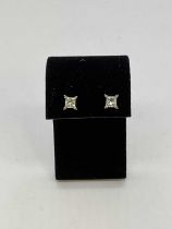 A pair of 18ct white gold diamond earstuds, the princess cut stones weighing 0.48and 0.50cts, graded