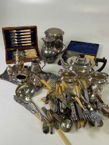 A quantity of silver plated items including a tea set, a decorative biscuit barrel, cutlery and