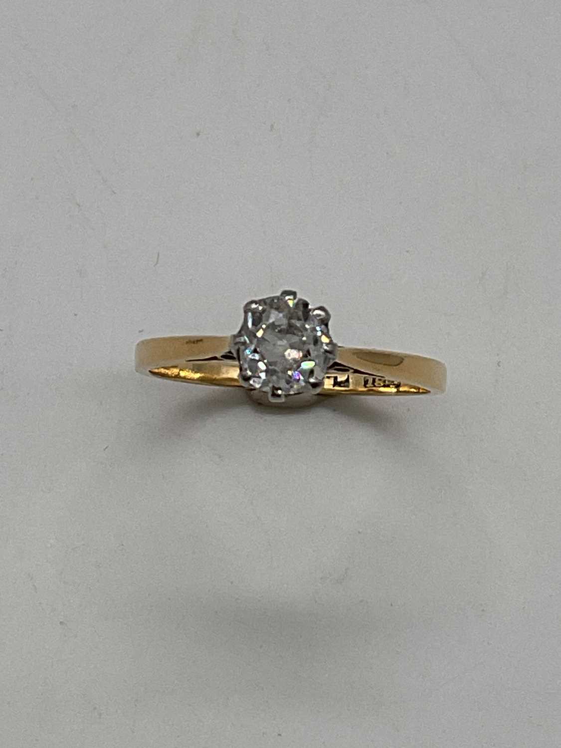 An 18ct yellow gold diamond solitaire ring, the cushion cut stone approx. 0.5cts. size M 1/2,
