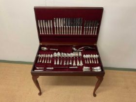 Canteen of cutlery; an EPNS cutlery set contained in a raised four legged wooden case with leather