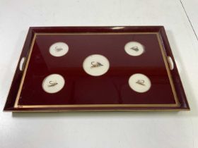 A glazed tray inset with five fishing flies, width 59cm.