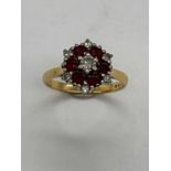 An 18ct yellow gold ruby and diamond dress ring, size O 1/2, approx. 4.6g.