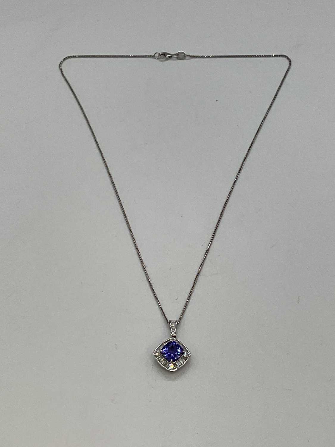 An 18ct white gold diamond and tanzanite pendant, the cushion cut tanzanite weighing 2.57cts