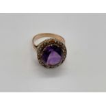 A 9ct yellow gold amethyst and pearl ring with pierced shoulders, size N, approx. 6g. Footnote: