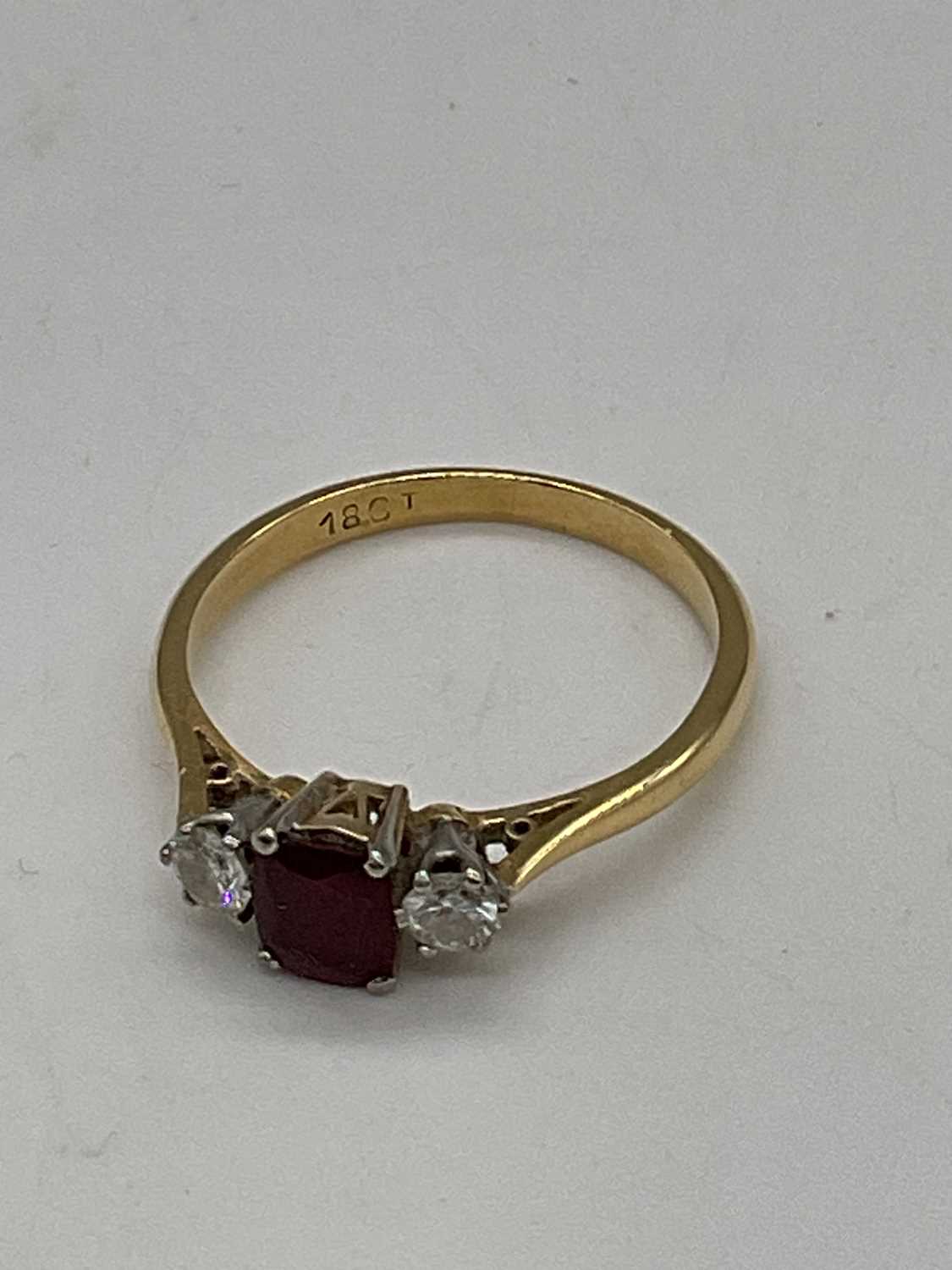 An 18ct yellow gold ruby and diamond three stone ring, the central cushion cut ruby flanked by - Image 3 of 6