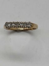 A 9ct yellow gold half eternity ring set with seven small diamonds, size O, approx. 1.65g.